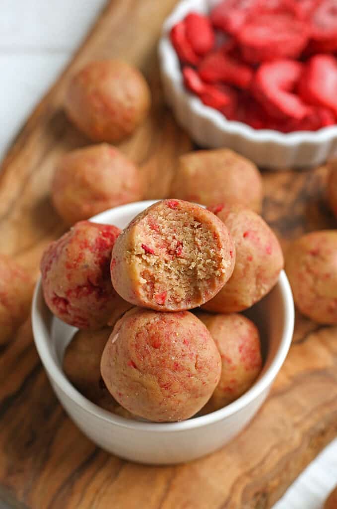 bowl of vegan paleo strawberry shortcake bites with a bite taken out of the top one