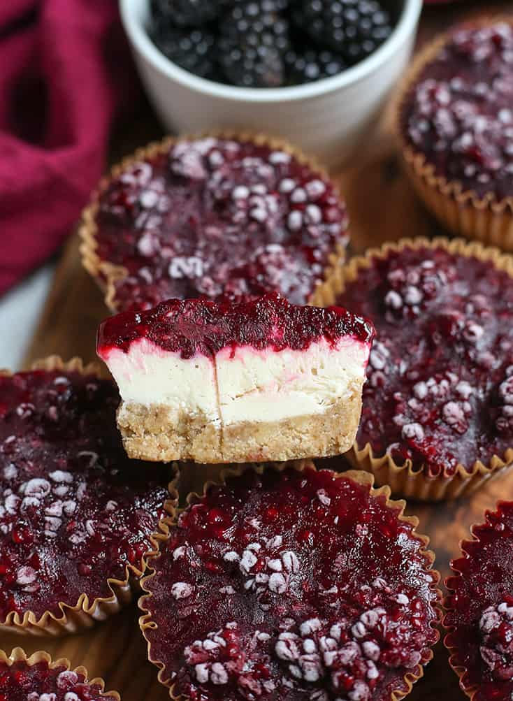 goat cheese blackberry cheesecake muffins with one cut open
