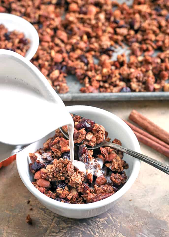 This Paleo Pumpkin Granola is healthy, easy, and so delicious!! Packed with nuts, coconut, and pumpkin and sweetened only with real maple syrup. This makes the perfect breakfast or snack. Gluten free, dairy free, and naturally sweetened. 