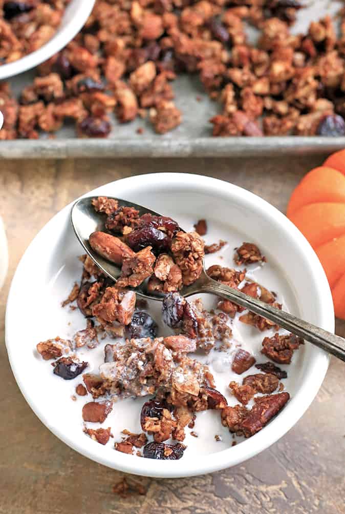 This Paleo Pumpkin Granola is healthy, easy, and so delicious!! Packed with nuts, coconut, and pumpkin and sweetened only with real maple syrup. This makes the perfect breakfast or snack. Gluten free, dairy free, and naturally sweetened. 