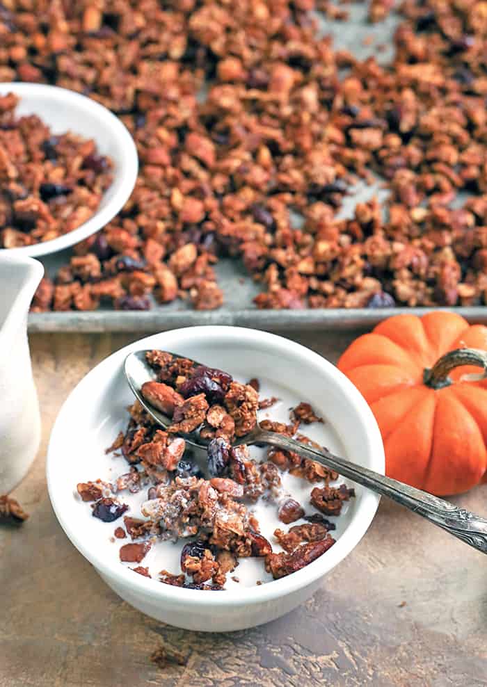 This Paleo Pumpkin Granola is healthy, easy, and so delicious!! Packed with nuts, coconut, and pumpkin and sweetened only with real maple syrup. This makes the perfect breakfast or snack. Gluten free, dairy free, and naturally sweetened. 