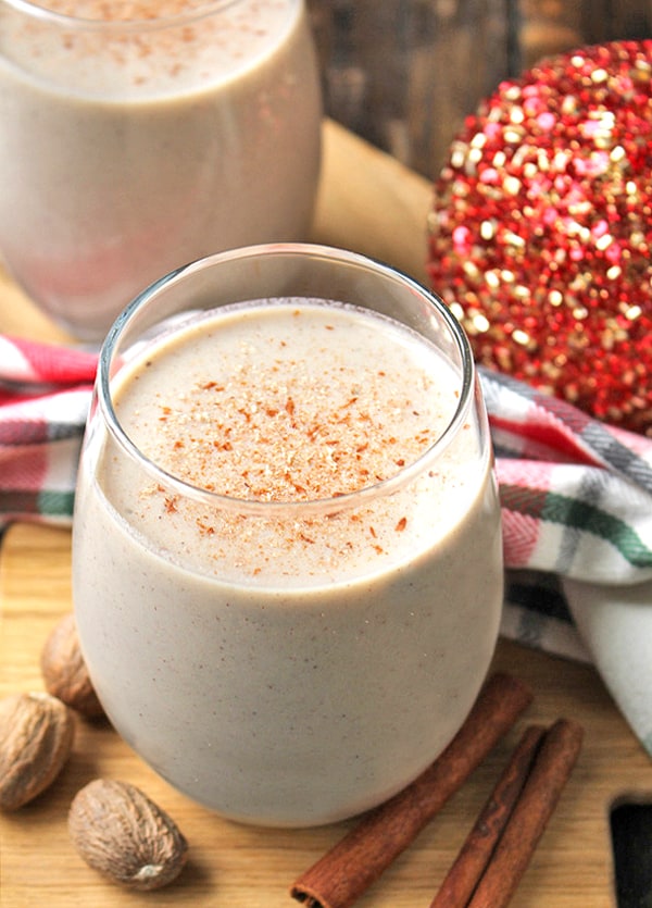dairy free eggnog in a glass with cinnamon on top. 