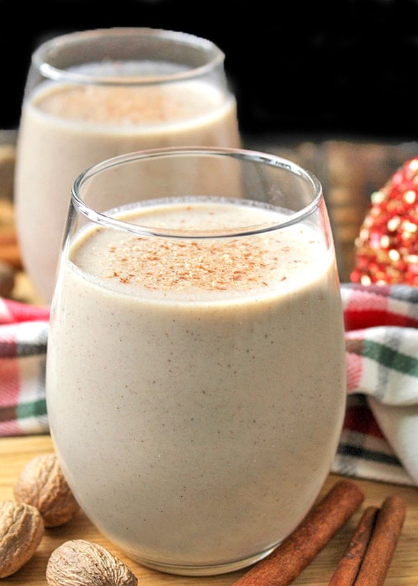 Homemade eggnog with a holiday towel in the background. 