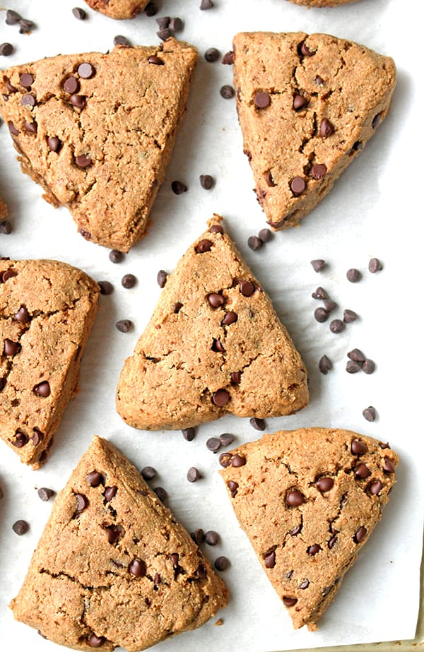 Six chocolate chip scones with mini chocolate chips between them. 