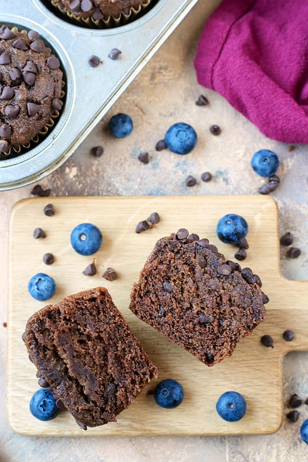 A gluten free chocolate muffin cut in half so the middle is showing. 