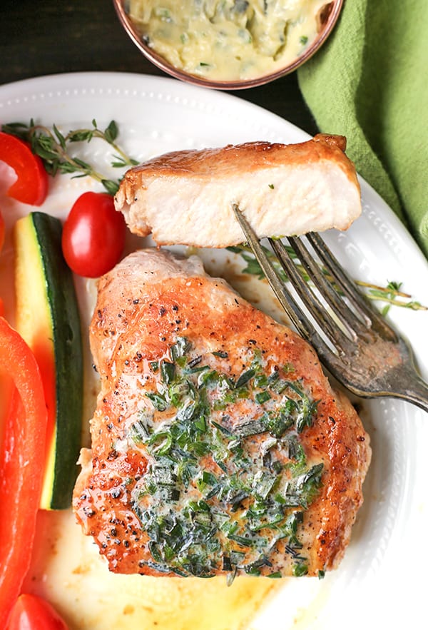 These Paleo Whole30 Pork Chops with Herbed Butter make a quick weeknight meal. Tender, juicy pork chops topped with an easy butter filled with fresh herbs. Gluten free, low carb, and keto.