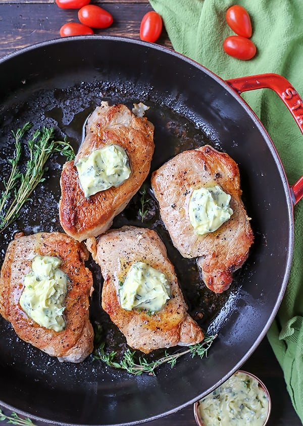 These Paleo Whole30 Pork Chops with Herbed Butter make a quick weeknight meal. Tender, juicy pork chops topped with an easy butter filled with fresh herbs. Gluten free, low carb, and keto.