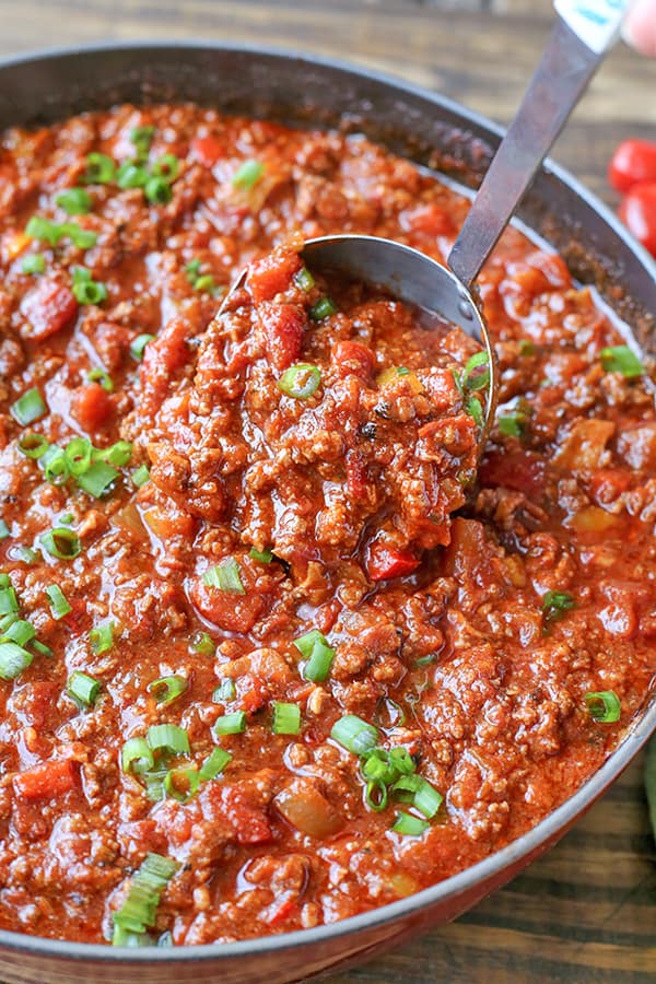 Pan of hearty with a ladle scooping. 