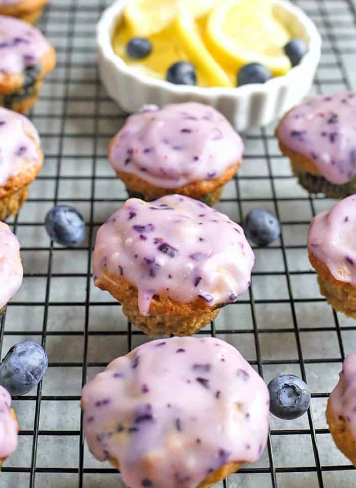 These Paleo Baked Blueberry Fritter Bites are easy to make and so delicious! Small, bite-size muffins covered in a blueberry glaze. They are gluten free, dairy free, and naturally sweetened.