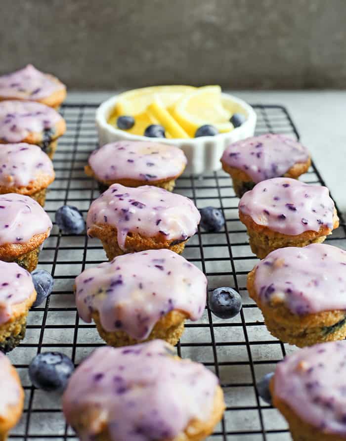 These Paleo Baked Blueberry Fritter Bites are easy to make and so delicious! Small, bite-size muffins covered in a blueberry glaze. They are gluten free, dairy free, and naturally sweetened.