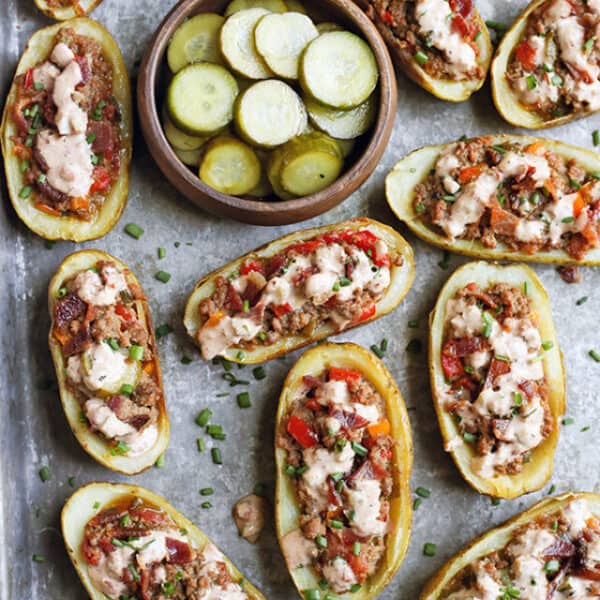 Bacon Hamburger Potato Skins served with pickles in a bowl