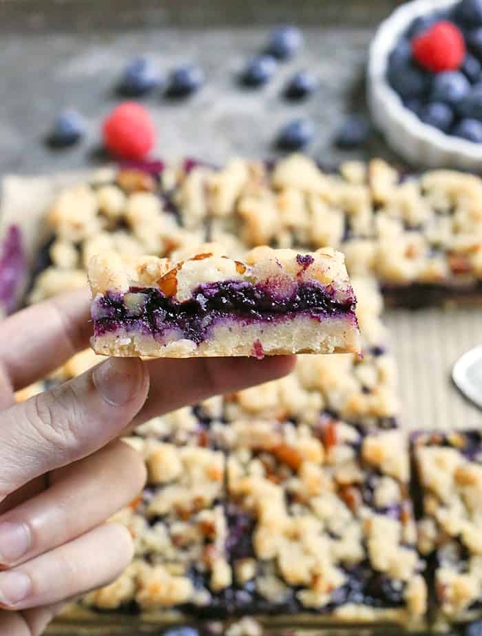 These Paleo Blueberry Pie Crumb Bars are simple to make and so delicious. A shortbread crust, thick layer of blueberries, and a crumble topping. These layered bars are gluten free, dairy free, vegan, and naturally sweetened.