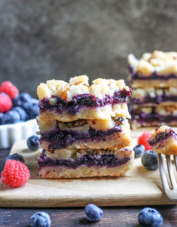 These Paleo Blueberry Pie Crumb Bars are simple to make and so delicious. A shortbread crust, thick layer of blueberries, and a crumble topping. These layered bars are gluten free, dairy free, vegan, and naturally sweetened.