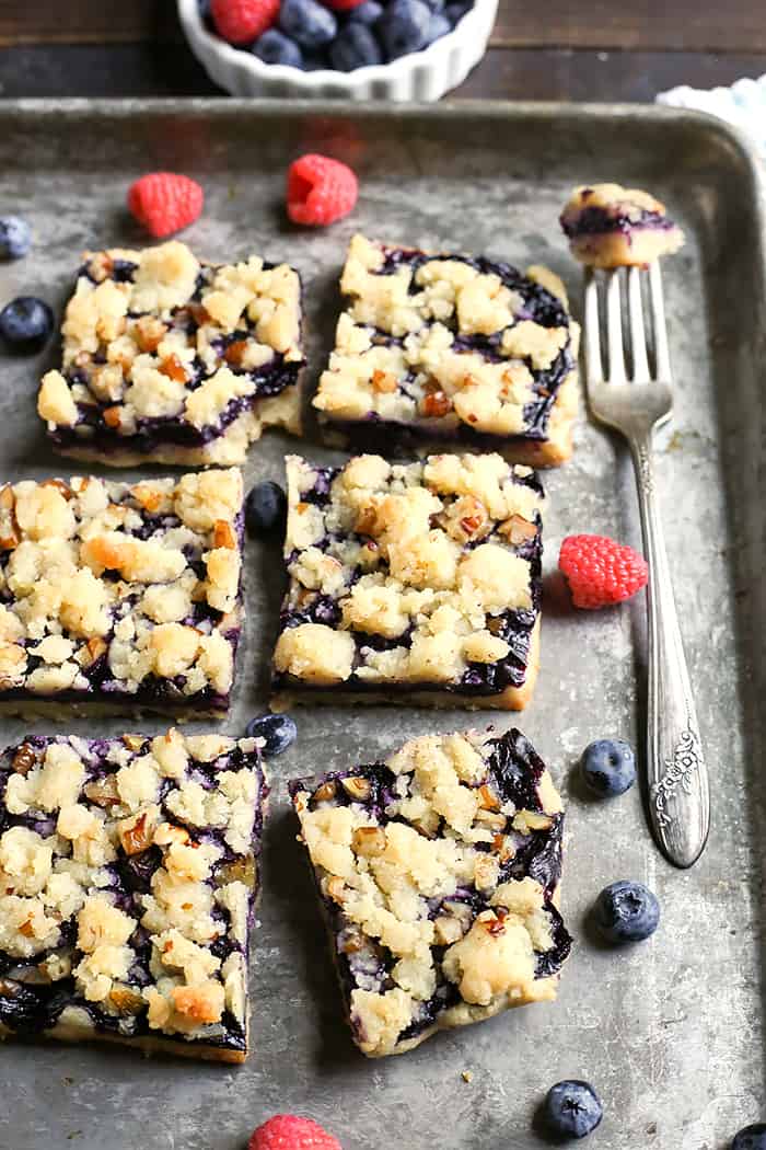 These Paleo Blueberry Pie Crumb Bars are simple to make and so delicious. A shortbread crust, thick layer of blueberries, and a crumble topping. These layered bars are gluten free, dairy free, vegan, and naturally sweetened.