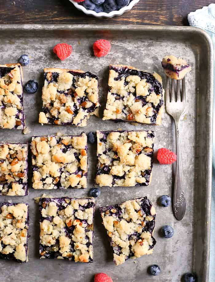 These Paleo Blueberry Pie Crumb Bars are simple to make and so delicious. A shortbread crust, thick layer of blueberries, and a crumble topping. These layered bars are gluten free, dairy free, vegan, and naturally sweetened.