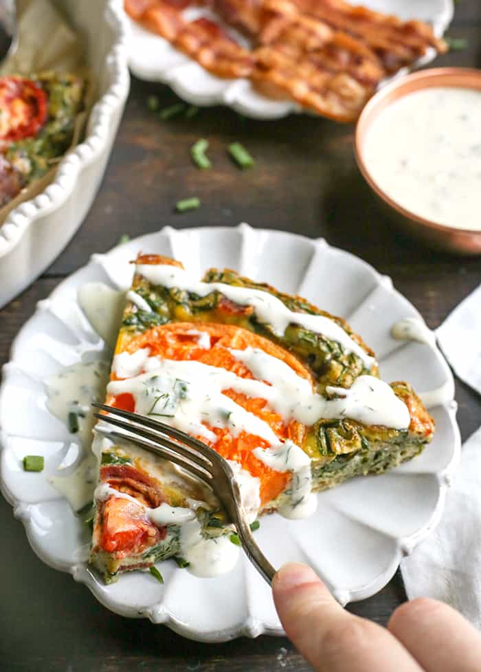 This Paleo Whole30 BLT Breakfast Bake has all the flavors of a BLT, but packed in a delicious egg bake. Crispy bacon, baby spinach, and fresh tomatoes combine for a tasty, filling breakfast. Gluten free, dairy free, low carb, and low fodmap.