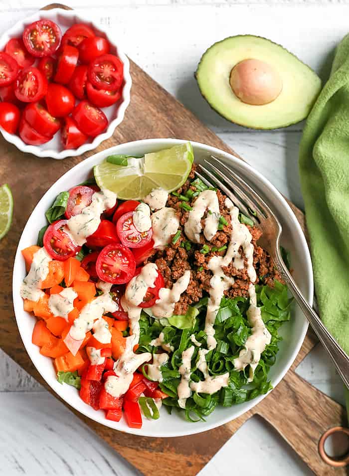 This Paleo Whole30 Taco Salad is an easy, filling, healthy meal that everyone will love. Seasoned meat and loads of veggies make for a complete meal and it's gluten free, dairy free, low fodmap, and low carb.