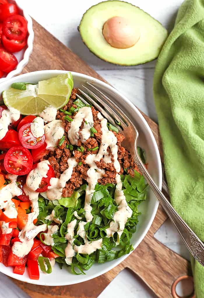 This Paleo Whole30 Taco Salad is an easy, filling, healthy meal that everyone will love. Seasoned meat and loads of veggies make for a complete meal and it's gluten free, dairy free, low fodmap, and low carb.