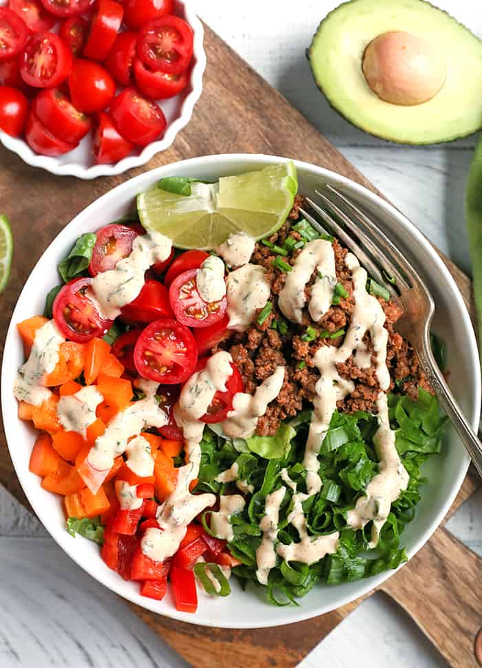 This Paleo Whole30 Taco Salad is an easy, filling, healthy meal that everyone will love. Seasoned meat and loads of veggies make for a complete meal and it's gluten free, dairy free, low fodmap, and low carb.