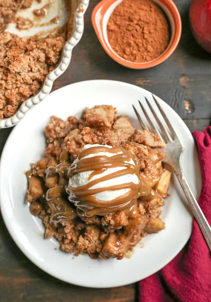 This Paleo Vegan Caramel Apple Crisp is the perfect fall treat! A simple caramel mixed together with the apples and topped with an irresistible crumb topping. Perfect with a scoop of dairy free ice cream and more caramel! It's gluten free, dairy free, and naturally sweetened.