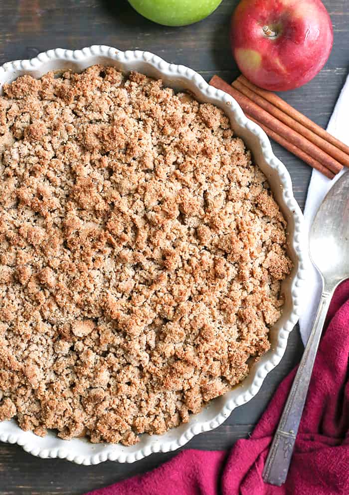 This Paleo Vegan Caramel Apple Crisp is the perfect fall treat! A simple caramel mixed together with the apples and topped with an irresistible crumb topping. Perfect with a scoop of dairy free ice cream and more caramel! It's gluten free, dairy free, and naturally sweetened.