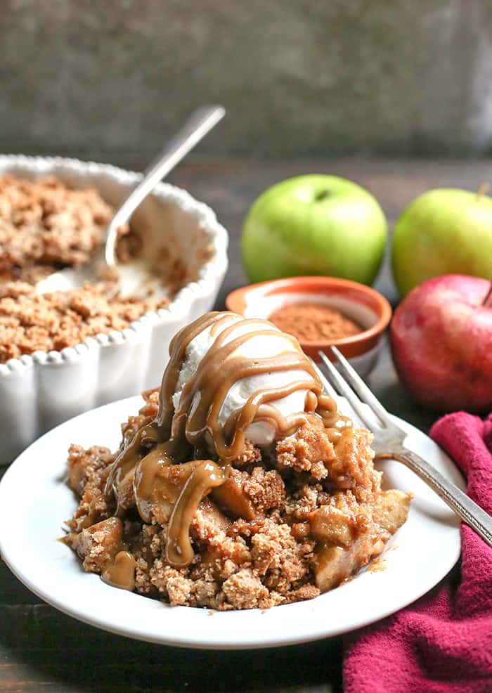 This Paleo Vegan Caramel Apple Crisp is the perfect fall treat! A simple caramel mixed together with the apples and topped with an irresistible crumb topping. Perfect with a scoop of dairy free ice cream and more caramel! It's gluten free, dairy free, and naturally sweetened.