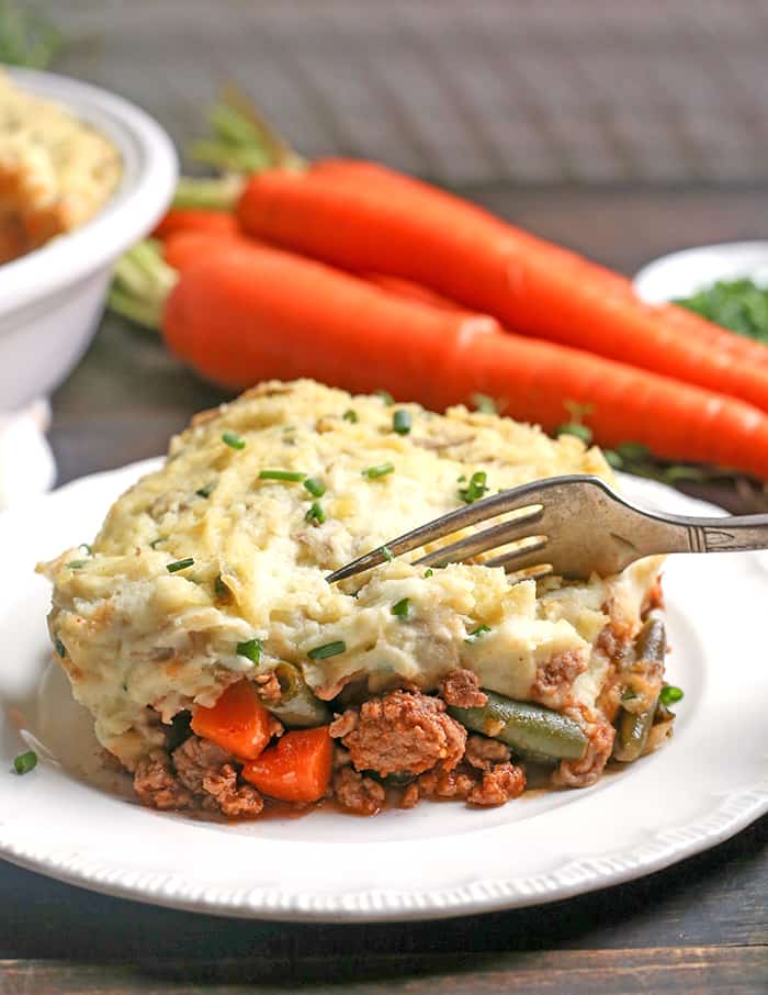 This Paleo Whole30 Shepherd's Pie is comfort food that is perfect for chilly days. A layer of lamb and veggies is topped with creamy mashed potatoes and baked together for one hearty meal. Everyone will love it! It's gluten free, dairy free, and low fodmap.