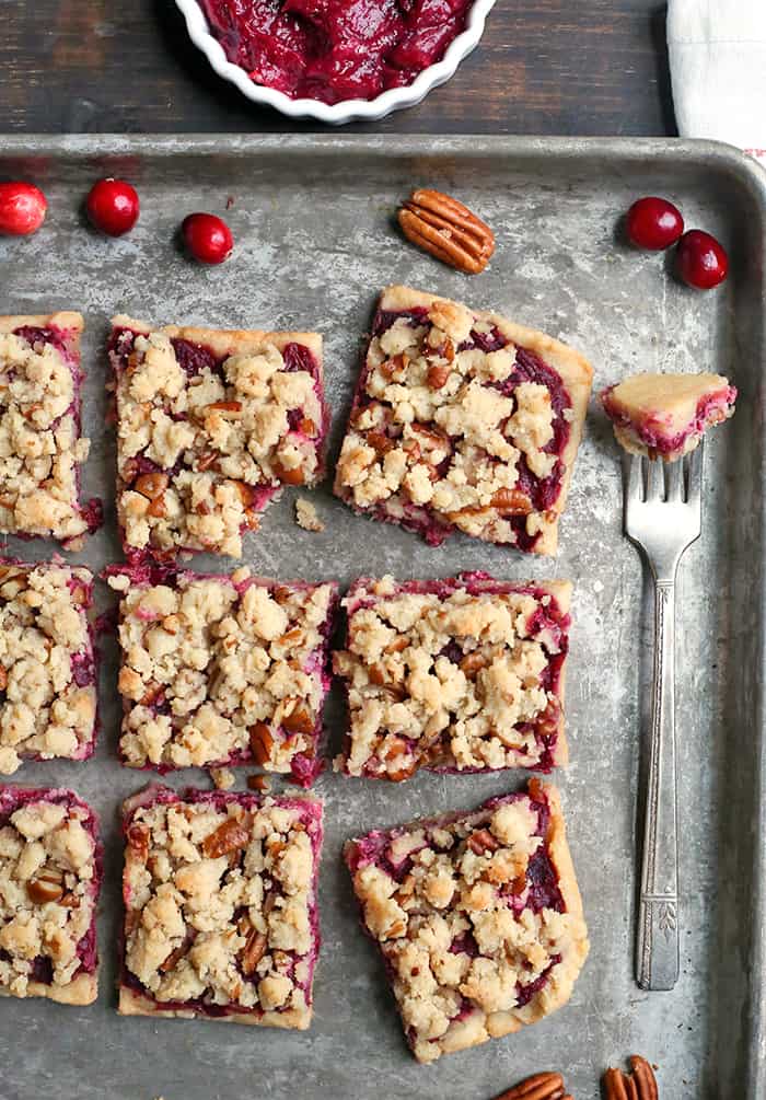 These Paleo Vegan Cranberry Crumb Bars are simple to make and so delicious! A shortbread crust, thick layer of cranberry sauce and then a delicious crumb topping. They are gluten free, dairy free and naturally sweetened.