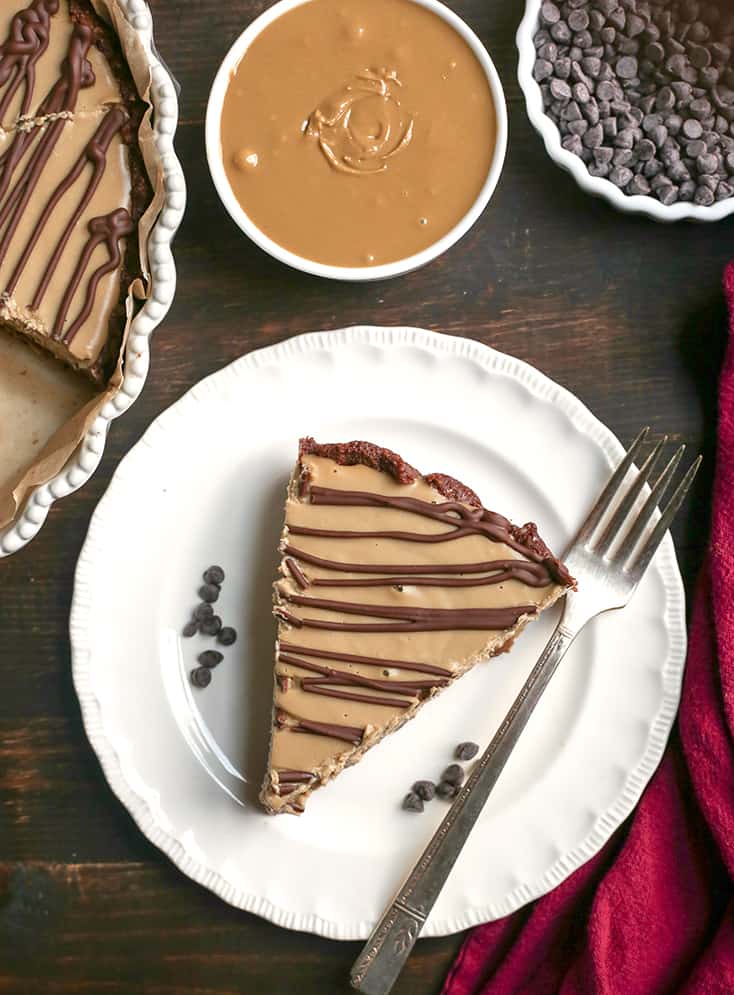 This Nut-Free Paleo Vegan Snickers Pie is an easy no-bake dessert and incredibly delicious! A chewy chocolate crust, creamy caramel layer and soft SunButter mousse. It's gluten free, dairy free, and naturally sweetened.