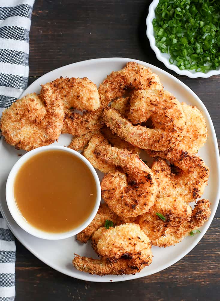 This Paleo Whole30 Air Fryer Coconut Shrimp is quick, easy, and delicious! Golden brown, crispy, and a great dinner or appetizer. They're gluten free, dairy free, and dipped in a naturally sweetened sauce.