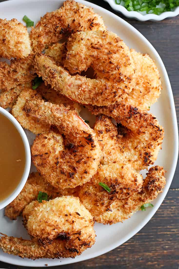 This Paleo Whole30 Air Fryer Coconut Shrimp is quick, easy, and delicious! Golden brown, crispy, and a great dinner or appetizer. They're gluten free, dairy free, and dipped in a naturally sweetened sauce.