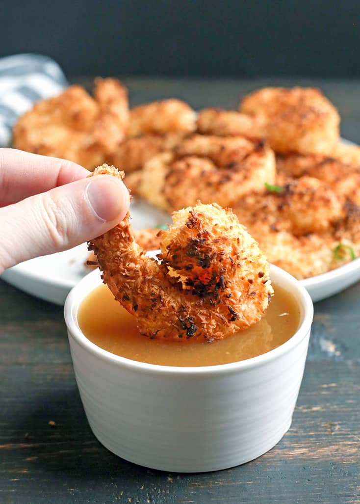This Paleo Whole30 Air Fryer Coconut Shrimp is quick, easy, and delicious! Golden brown, crispy, and a great dinner or appetizer. They're gluten free, dairy free, and dipped in a naturally sweetened sauce.