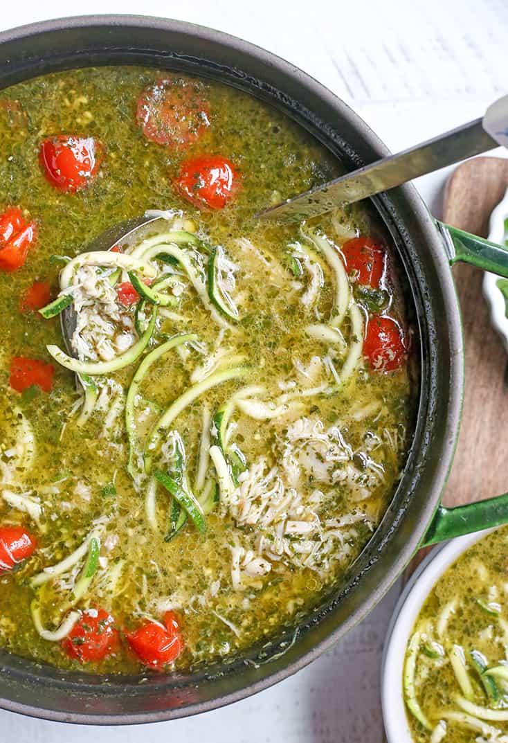 This Paleo Whole30 Pesto Chicken Zoodle Soup is quick, easy, and so delicious! Tender chicken, flavorful pesto, and perfectly cooked zucchini noodles make this so delicious. Gluten free, dairy free, and low FODMAP.