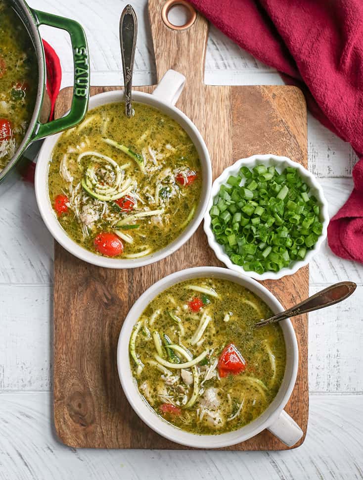 This Paleo Whole30 Pesto Chicken Zoodle Soup is quick, easy, and so delicious! Tender chicken, flavorful pesto, and perfectly cooked zucchini noodles make this so delicious. Gluten free, dairy free, and low FODMAP.