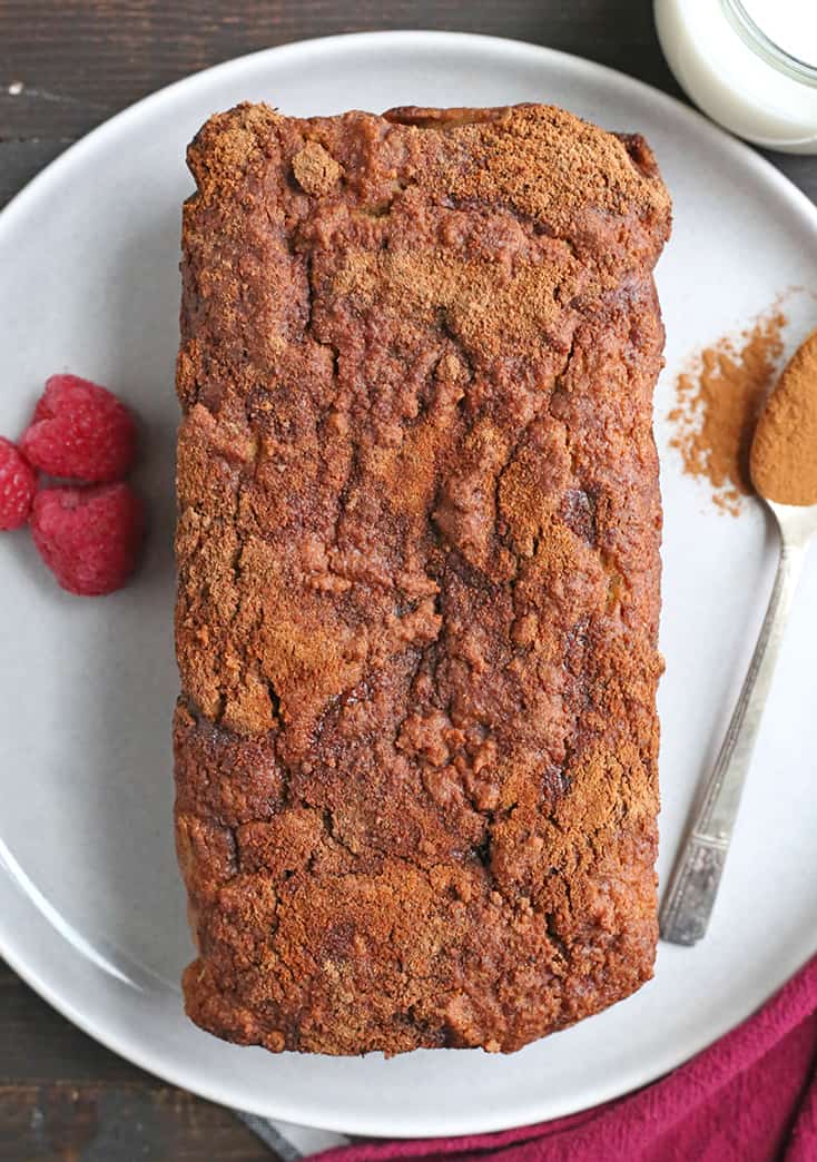 This Paleo Cinnamon Roll Quick Bread is so easy to make and tastes incredible! Tender cake with a sweet cinnamon swirl and drizzled with a thick glaze. Gluten free, dairy free, and naturally sweetened.