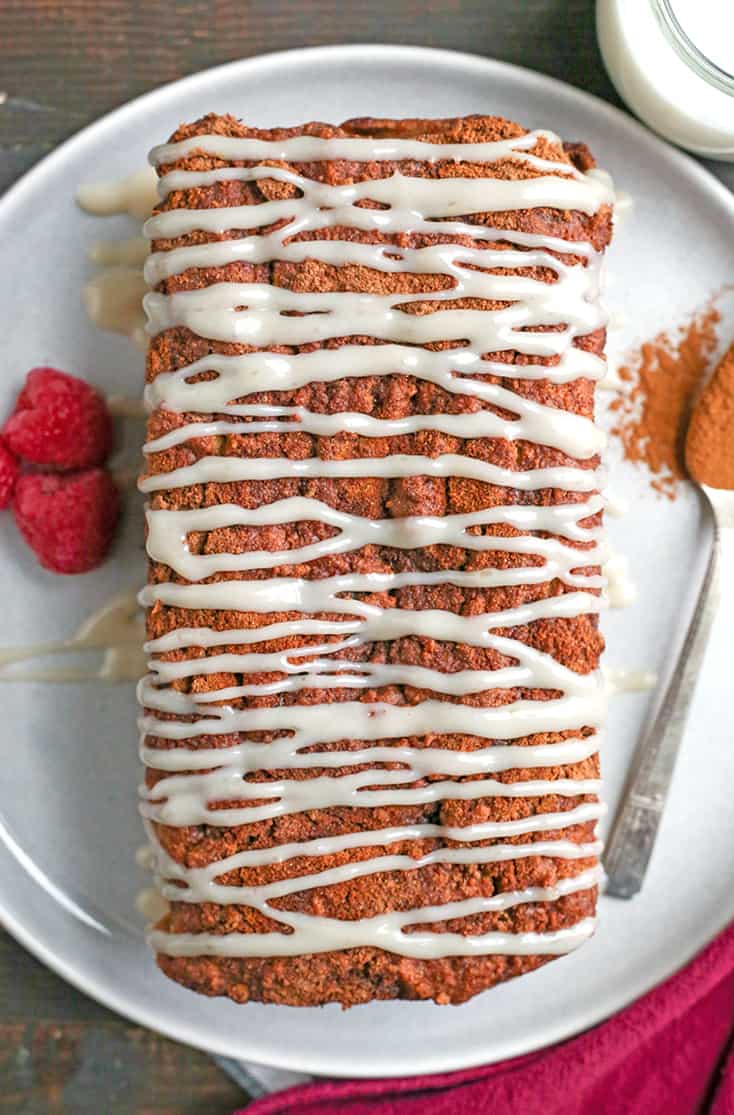 This Paleo Cinnamon Roll Quick Bread is so easy to make and tastes incredible! Tender cake with a sweet cinnamon swirl and drizzled with a thick glaze. Gluten free, dairy free, and naturally sweetened.