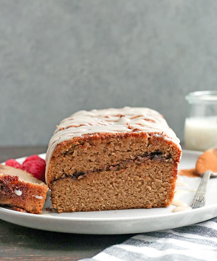 This Paleo Cinnamon Roll Quick Bread is so easy to make and tastes incredible! Tender cake with a sweet cinnamon swirl and drizzled with a thick glaze. Gluten free, dairy free, and naturally sweetened.