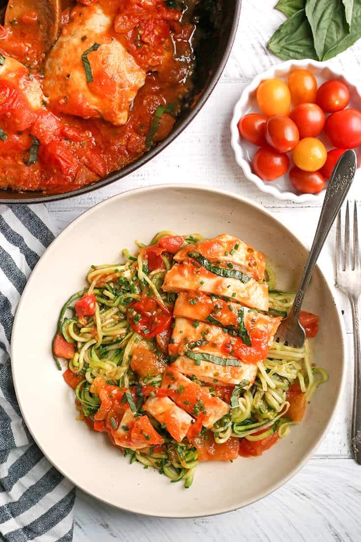 This Paleo Whole30 Garlic Tomato Basil Chicken is quick and so easy. A fresh tomato sauce and tender chicken that is ready in 20 minutes. Gluten free, dairy free, low carb, and low FODMAP.