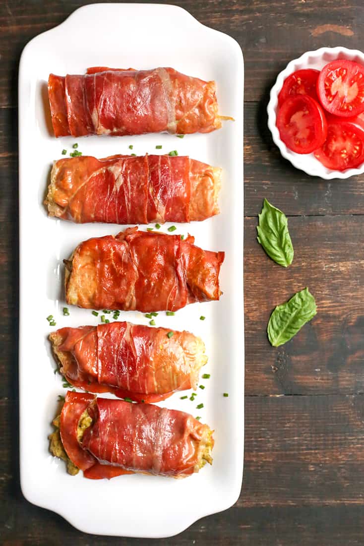 These Paleo Whole30 Pesto Prosciutto Egg Wraps are a fun, handheld breakfast. Tender cooked eggs wrapped in crispy proscuitto making a healthy burrito. They are gluten free, dairy free, low carb and low FODMAP.