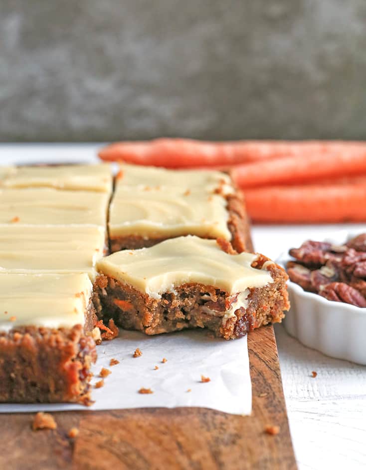 These Paleo Vegan Carrot Cake Bars are easy to make and so tasty. Moist, spiced just right, and topped with a delicious  frosting. Gluten free, dairy free, egg free, and naturally sweetened.