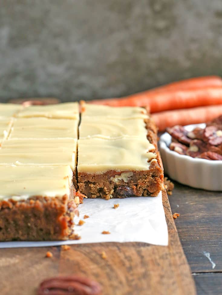 These Paleo Vegan Carrot Cake Bars are easy to make and so tasty. Moist, spiced just right, and topped with a delicious  frosting. Gluten free, dairy free, egg free, and naturally sweetened.