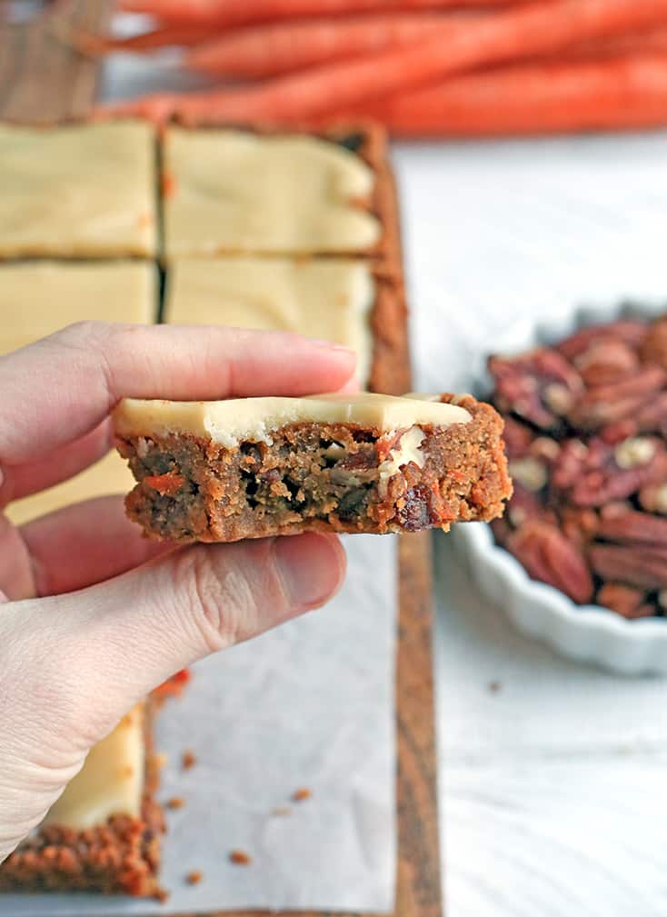 These Paleo Vegan Carrot Cake Bars are easy to make and so tasty. Moist, spiced just right, and topped with a delicious  frosting. Gluten free, dairy free, egg free, and naturally sweetened.