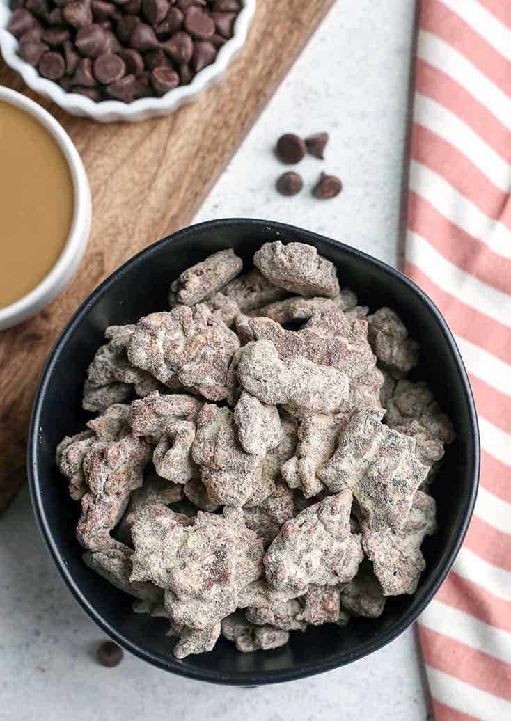 These Paleo Nut-Free Muddy Buddies (also known as Puppy Chow) are easy to make and so delicious. A chocolate and SunButter mixture poured over sunflower seeds and dusted with maple sugar. They are gluten free, dairy free, vegan, and naturally sweetened.