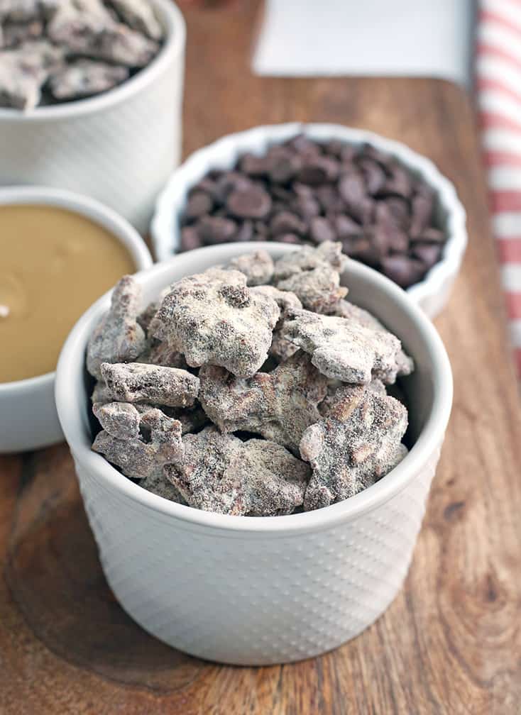 These Paleo Nut-Free Muddy Buddies (also known as Puppy Chow) are easy to make and so delicious. A chocolate and SunButter mixture poured over sunflower seeds and dusted with maple sugar. They are gluten free, dairy free, vegan, and naturally sweetened.