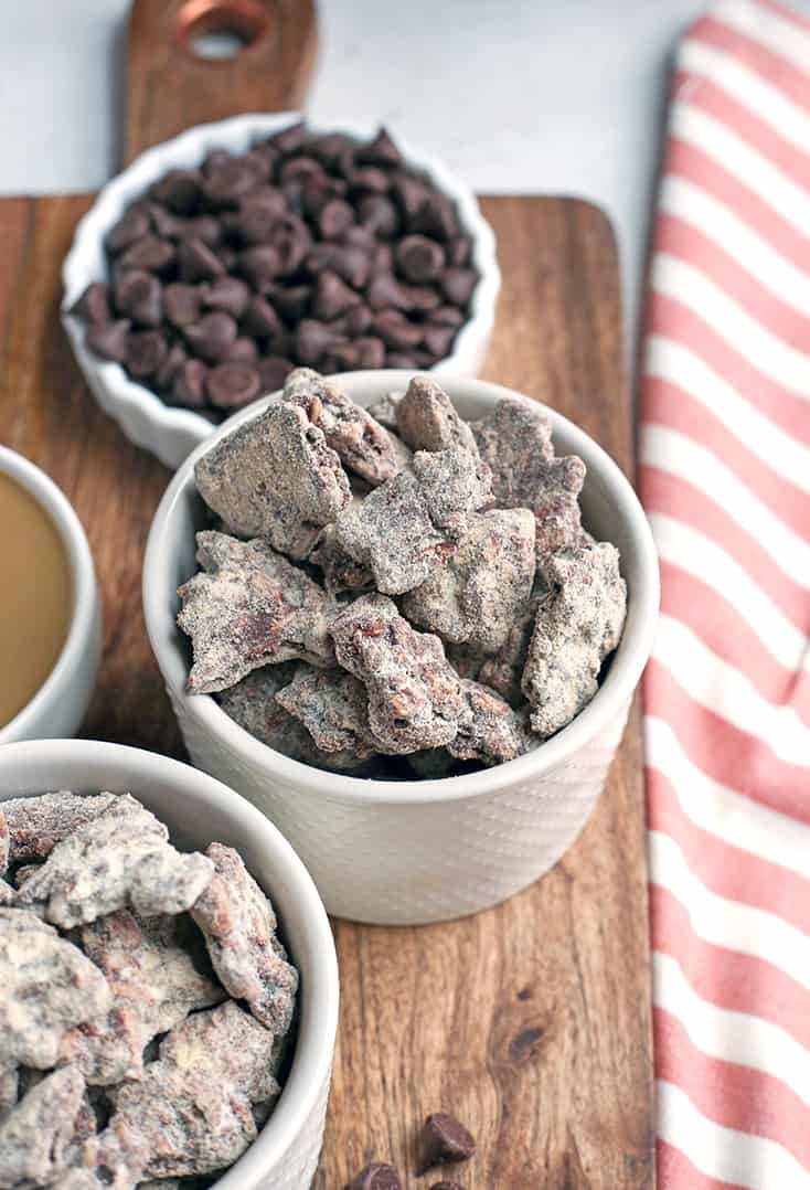 These Paleo Nut-Free Muddy Buddies (also known as Puppy Chow) are easy to make and so delicious. A chocolate and SunButter mixture poured over sunflower seeds and dusted with maple sugar. They are gluten free, dairy free, vegan, and naturally sweetened.