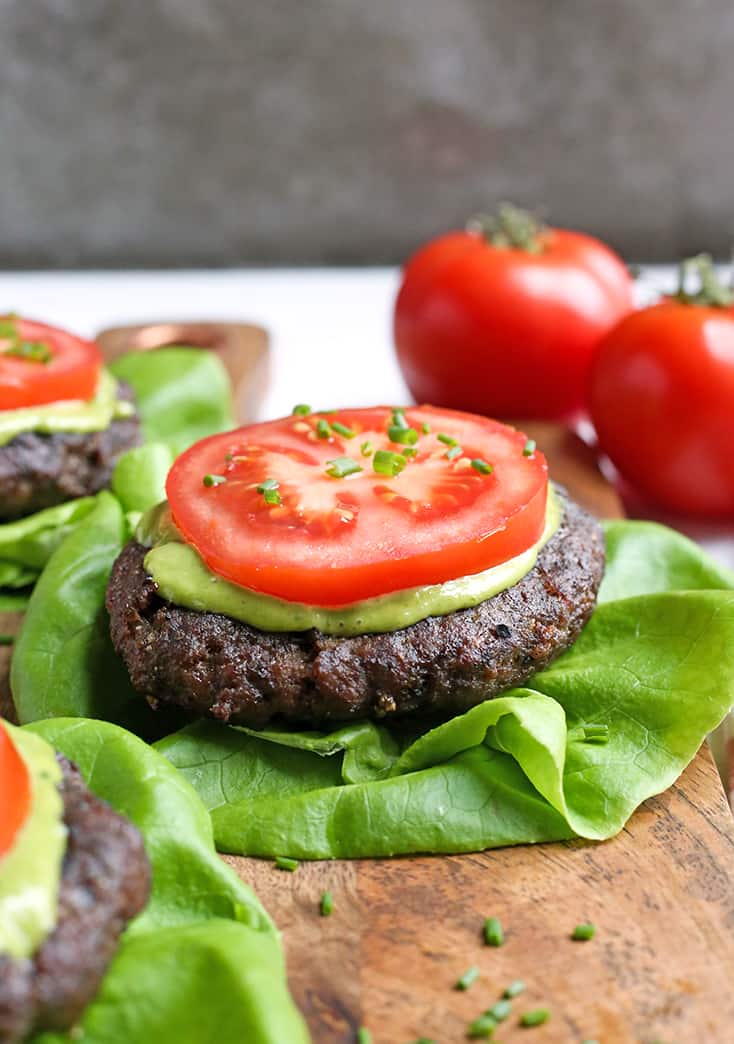 These Paleo Whole30 Pesto Turkey Burgers are easy to make and so delicious! A simple pesto gets mixed with the meat and they are grilled to perfection. Gluten free, dairy free, low carb and low FODMAP.