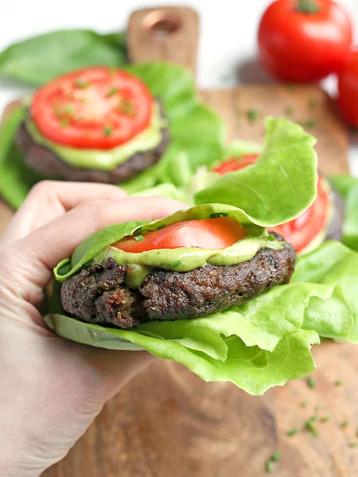 These Paleo Whole30 Pesto Turkey Burgers are easy to make and so delicious! A simple pesto gets mixed with the meat and they are grilled to perfection. Gluten free, dairy free, low carb and low FODMAP.