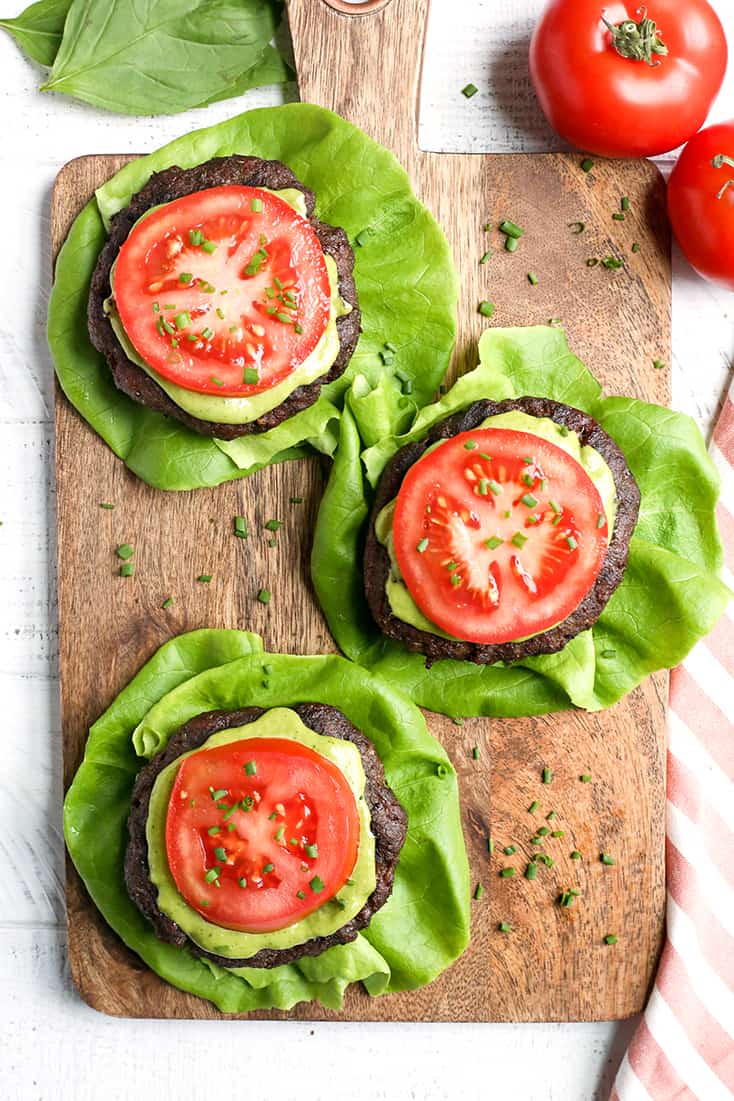 These Paleo Whole30 Pesto Turkey Burgers are easy to make and so delicious! A simple pesto gets mixed with the meat and they are grilled to perfection. Gluten free, dairy free, low carb and low FODMAP.