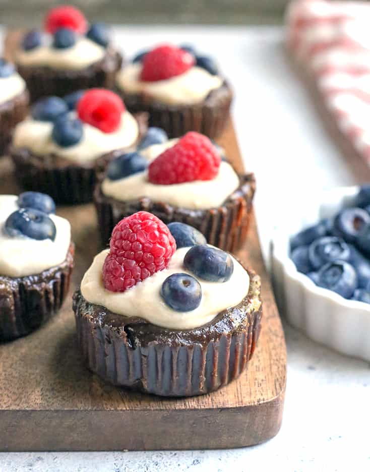 These Paleo Pudding Filled Brownie Bites are such a fun dessert. An easy brownie is made in a muffin pan and filled with dairy free pudding and topped with berries. They're dairy free, gluten free, low FODMAP, and naturally sweetened.