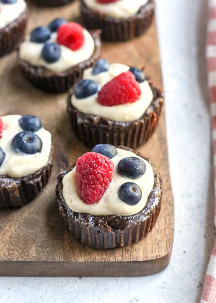 These Paleo Pudding Filled Brownie Bites are such a fun dessert. An easy brownie is made in a muffin pan and filled with dairy free pudding and topped with berries. They're dairy free, gluten free, low FODMAP, and naturally sweetened.